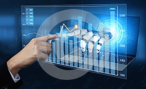 Futuristic robotic hand interacting with data analytics on a laptop screen showcasing vibrant graphs and digital
