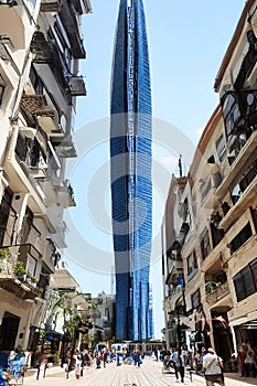 futuristic skyscraper in the middle of the old city, realistic, kids story book style, muted colors, watercolor style, Ai