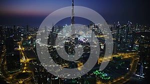 Futuristic skyscrapers of beautiful night light Dubai cityscape aerial drone panorama