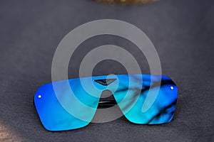 Futuristic sunglasses model rimless with blue lenses reflecting the sun in a summer day shoot outside closeup. Selective