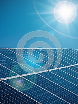 Futuristic sunny background of solar power plant with sun and blue sky