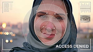 Futuristic and technological scanning of the face of a beautiful woman in hijab for facial recognition and scanned