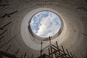 Futuristic view inside of cooling tower of unfinished Chernobyl nuclear power plant. Catastrophe, industry.