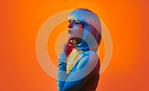 Futuristic woman in blue wig against orange light