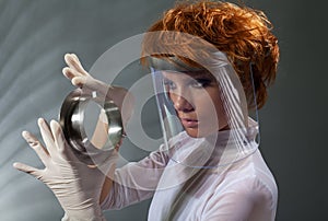 Futuristic woman examine metal detail photo