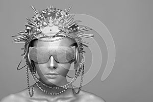 Futuristic woman in metal helmet and glasses