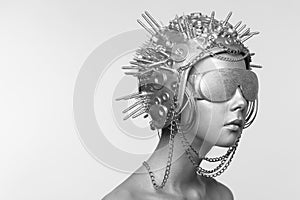 Futuristic woman in metal helmet and glasses