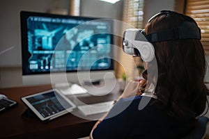 Futuristic women Engineer Wearing Virtual Reality Glasses working with a futuristic hologram to analysis and create alternative