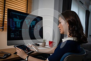 Futuristic women Engineer working with Holographic Augmented Reality and 3D Wind Turbine Model on computer and tablet at home