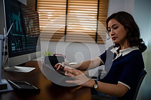 Futuristic women Engineer working with Holographic Augmented Reality and 3D Wind Turbine Model on computer and tablet at home