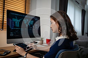 Futuristic women Engineer working with Holographic Augmented Reality and 3D Wind Turbine Model on tablet at home office ,Concept