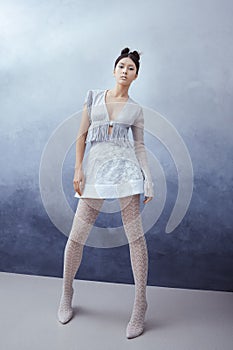 Futuristic young asian woman in full lenght.