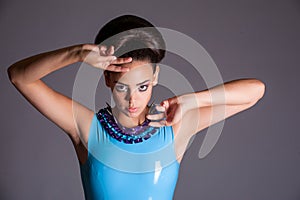 Futuristic young lady in blue latex dress