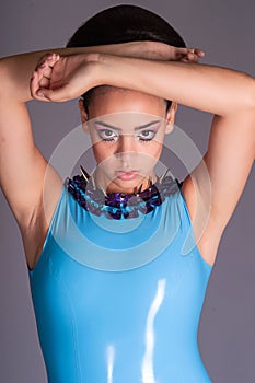 Futuristic young lady in blue latex dress