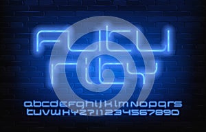 Futurity alphabet font. Blue neon letters, numbers and symbols. Brick wall background.