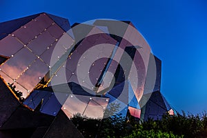 Futuroscope, glass buliding with sunset over Poitiers town mirrored in the glass walls photo