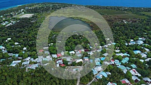 Fuvahmulah island in Maldives with local town, lake and ocean coastline. Aerial view