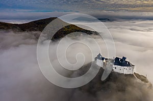 Fuzer, Hungary - Aerial panoramic view of the beautiful Castle of Fuzer standing out of the fog on an foggy autumn morning