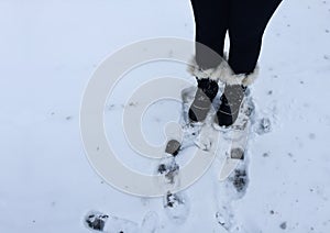 Fuzzy boots leaving footprints in snow