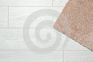 Fuzzy carpet on wooden background, top view