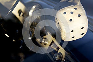 Fuzzy Dice Dangling from Classic Car Rearview Mirror with Dashboard