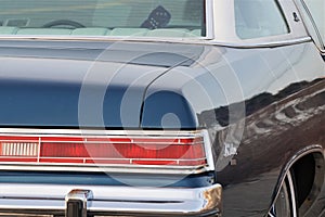 Fuzzy dice hang from mirror in LeSabre vintage car