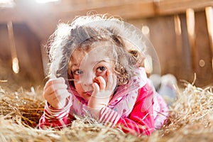 Fuzzy Haired Child in Hay