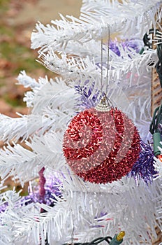 Fuzzy red glitter Christmas ornament hanging white Christmas tree
