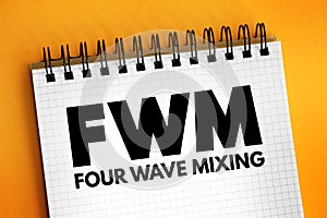 FWM - Four-Wave Mixing acronym text on notepad, abbreviation concept background