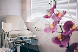 Fyazino, Russia - 06 11 2018: gynecological chair in the doctor's office, Orchid flower. women's health concept