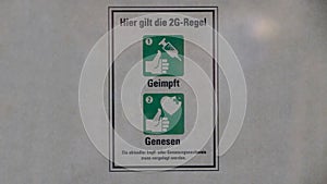2G Corona warning sign on a store in Germany photo