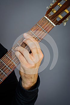 G minor chord played by Guitarist on classical acoustic guitar