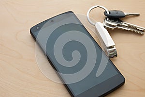 4G Smartphone wite house key on wood floor photo