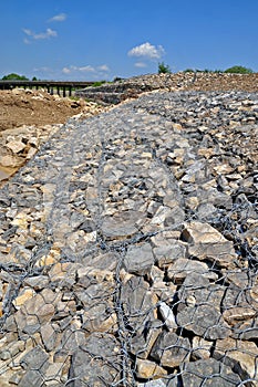 Gabion on the bank of the river photo