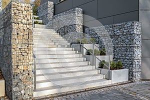 Modern concrete staircase with gabion fence as an eye-catcher