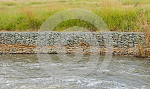 Gabion retaining walls on the bank of a river
