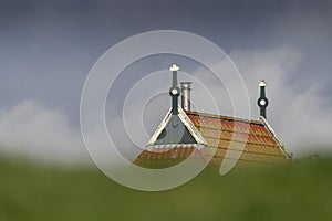 Gable of a farm behind a dike