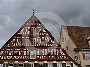 Gable of old half-timbered house at the town square of Esslingen am Neckar, Germany on cloudy summer day.