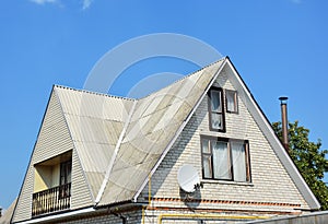 Gable and Valley type of roof construction. Building attic white brick house construction with different types of roof designs