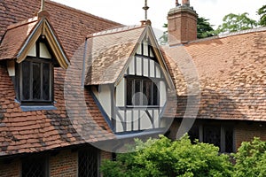 gabled roof and half-timbering of tudor house, with view toward courtyard