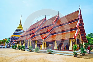 The gabled roof of Viharn Luang and Chedi of Wat Phra That Lampang Luang Temple, Lampang, Thailand