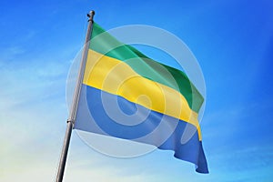 Gabon flag waving on the blue sky 3D illustration