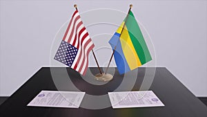 Gabon and USA at negotiating table. Business and politics 3D illustration. National flags, diplomacy deal. International