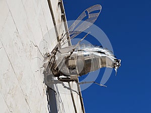 Metal bee crashed into the wall, humorous installation in the building of the museum of humor