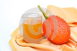 Gac fruit and juice isolated on white.