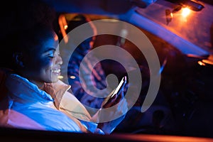 Gadget addicted man and woman couple sit in car in silence using smartphones browsing social media