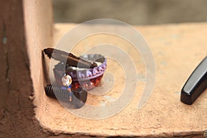 Top View Photo, Gadget Freak or addicted, Sitting Man Holding Smartphone at Corrosive Screw under stack of bottle cups