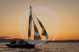 gaff-rigged sloop at sunset