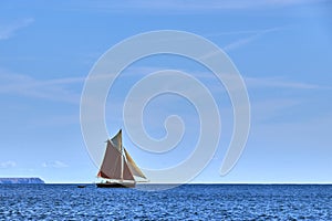 Gaff Rigged Sailing Boat on smooth sea photo