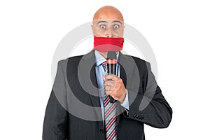 Gagged businessman with microphone